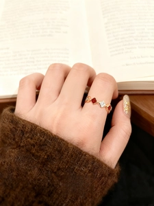 Macro detail of 18k gold plated gourd ring with red enamel and zircon on model hand