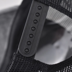 Close-up of adjustable plastic snapback closure on a black mesh trucker baseball cap