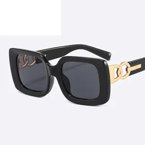 Modern thick square frame sunglasses in glossy black with gold chain link temple detail