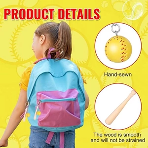 Detail of hand-sewn yellow softball and mini wooden baseball bat keychain on backpack
