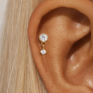 Close-up of gold S925 silver cartilage stud featuring two sparkling round cubic zirconia