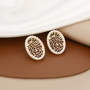 Detail of gold oval studs with hollow rose pattern and white pearl border in French style