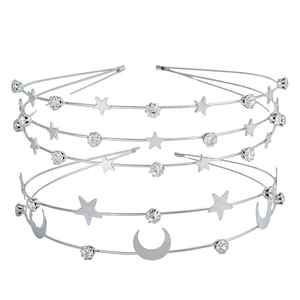 Close-up of bohemian silver star and moon headbands with sparkling rhinestones set