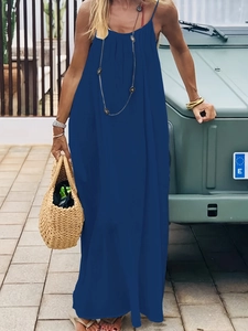 Detail of loose dark blue maxi dress with straps and bohemian vacation style accessories