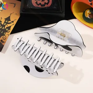 Close-up of ghost hair claws with golden metal springs and white acetate finish