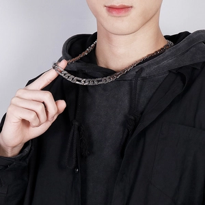 Close-up of vintage Cuban chain necklace in flat titanium steel worn by a male model