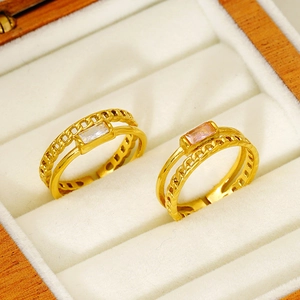 Gold double-layer cutout rings with rectangular zircons on a white velvet display case