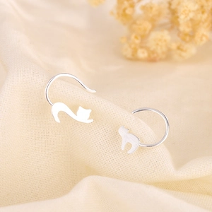 Creative S925 sterling silver cat ear hooks with a matte finish on a linen background