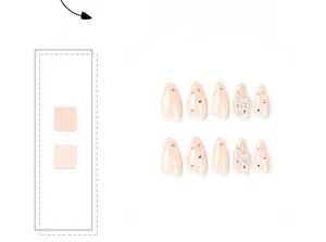 Detail of nude pink almond press-on nails featuring silver cross stars and tiny rhinestones