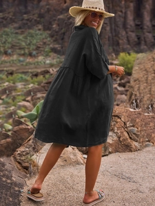 Detail of loose fit black polo collar shirt dress with natural fabric texture for vacation