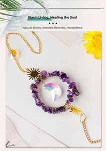 Detail of amethyst crystal suncatcher with moon prism and golden hollow sun charm