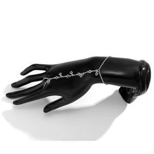 Detailed view of silver chain hand harness with rhinestones on a display hand