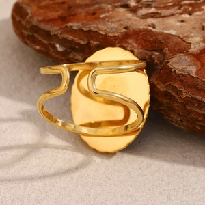 Detailed shot of retro gold-plated starfish ring on natural textured rock background