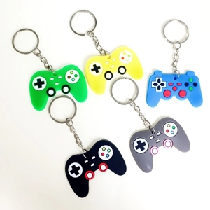 Detailed view of five colorful PVC game controller keychains in blue, green and yellow