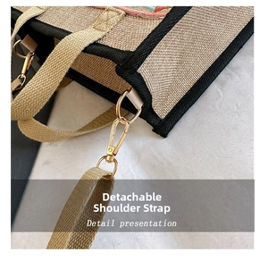 Detail showing the detachable woven shoulder strap and golden metal clasp on jute tote bag