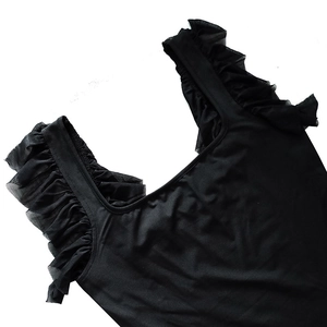 Detail of square neckline and ruffled mesh shoulder straps on a black dress