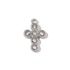 Macro shot of silver cross pendant with six round rhinestones on white background