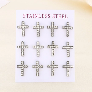 Macro shot of twelve silver stainless steel cross earrings with sparkling crystals