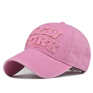 Detailed close-up of pink washed cotton baseball cap with vintage New York embroidery