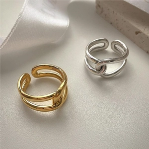 Close-up of dual-layer intertwined S925 sterling silver rings in gold and silver finish