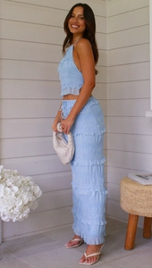 Close-up of light blue pleated chiffon tiered skirt and ruffled sleeveless crop top