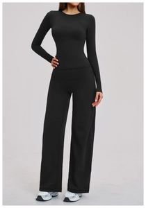 Detail of high-elastic black yoga set with long sleeve top and wide leg pants