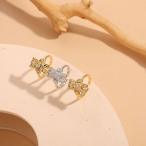 Close-up of bear-shaped zircon rings in gold and silver finishes with full diamond inlay