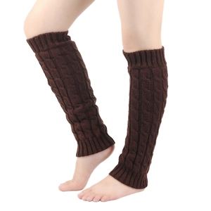 Close-up of dark brown cable knit leg warmers with elastic ribbed cuffs and texture