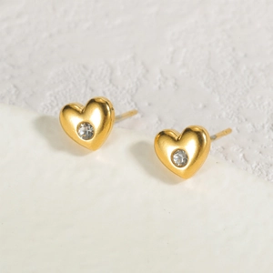 Minimalist heart-shaped stud earrings in 18K gold plated stainless steel with clear crystals