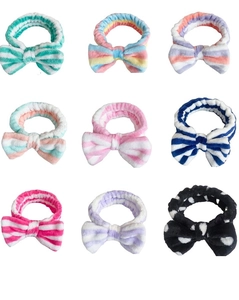 Detailed grid view of nine colorful coral fleece headbands with decorative bow knots