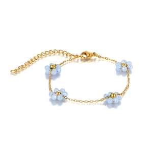 Detail of adjustable gold chain bracelet with blue beaded flowers and lobster clasp