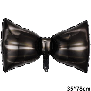 Detail of a black bow-shaped foil balloon with metallic finish and size 35x78cm mark