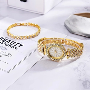 Luxury gold-tone women's watch and bracelet set with rhinestones and floral dial