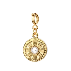 Detail of a vintage golden sunburst pendant with a centered pearl and lobster clasp