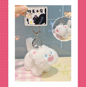 Detailed close-up of a fluffy white cat plush keychain with a bell and display card