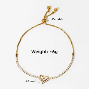 Detail of adjustable golden heart bracelet with zircon pavé and pullable chain closure
