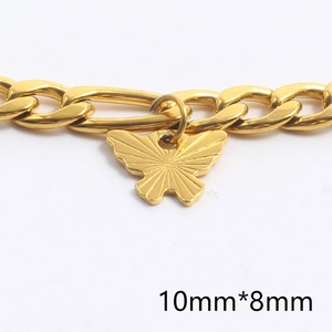 Vintage gold butterfly pendant necklace with engraved texture on a Figaro chain
