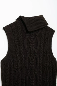 Detail shot of black high-neck knit vest featuring classic thick cable knit texture