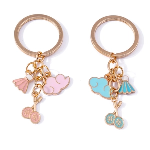 Cloud badminton racket keychain with pink and blue shuttles on golden rings