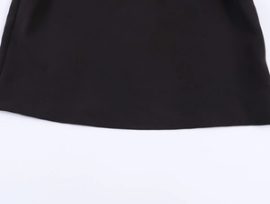Detailed close-up showing the precise stitching on the hem of this black polo shirt
