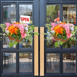 Artificial pink dahlia and orange daisy hanging baskets for outdoor patio door decor