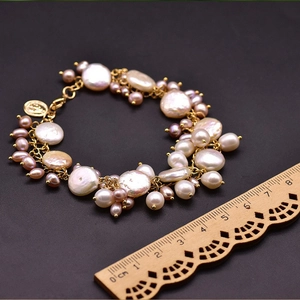 Detail of baroque pearl bracelet showing white and pink pearls with a gold pendant