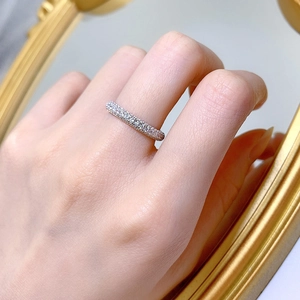 Macro detail of a slim S925 sterling silver ring with sparkling pavé zircon stones