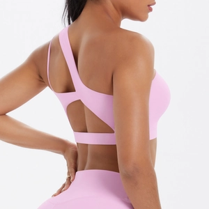 Detail of pink sports bra featuring asymmetric back straps and breathable cutout design