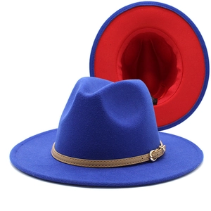Detail of blue wool fedora hat featuring red brim lining and khaki faux leather belt