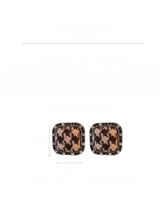 Detail of square houndstooth earrings with brown beige patterns and rhinestone border
