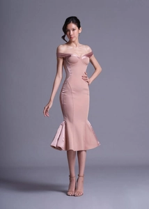 Detail of dusty pink velvet off-shoulder dress featuring corset bodice and mermaid hem