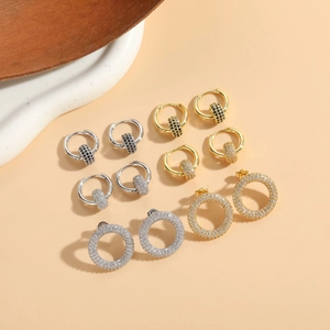 Macro shot of assorted gold and silver zircon earrings in various round circle designs