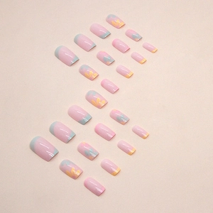 Pink French square press-on nails with blue tips and floral nail art patterns
