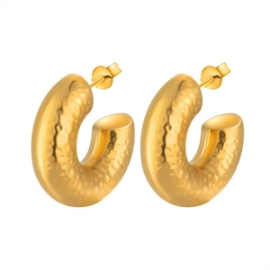 Detailed view of golden hammered texture C-shaped earrings in polished titanium steel